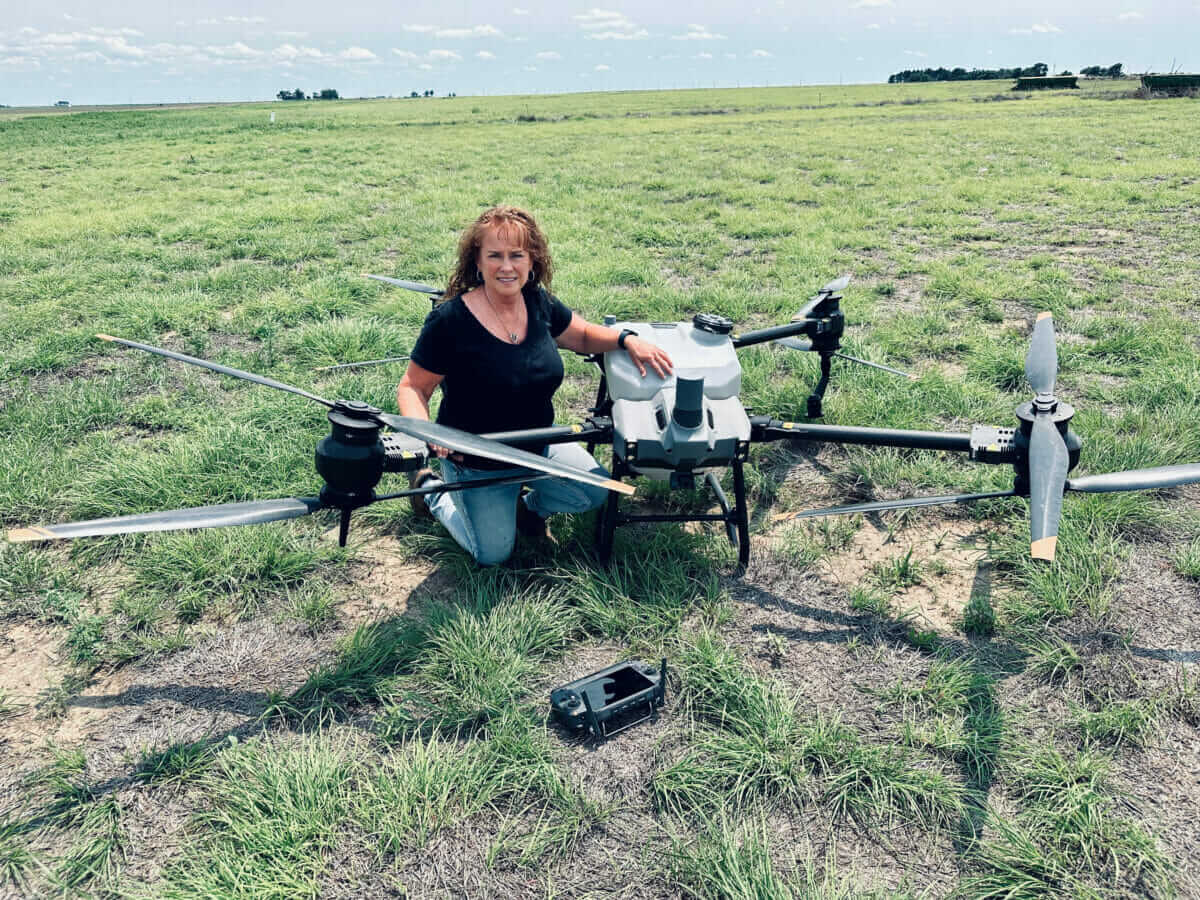 A person with a drone in a field.